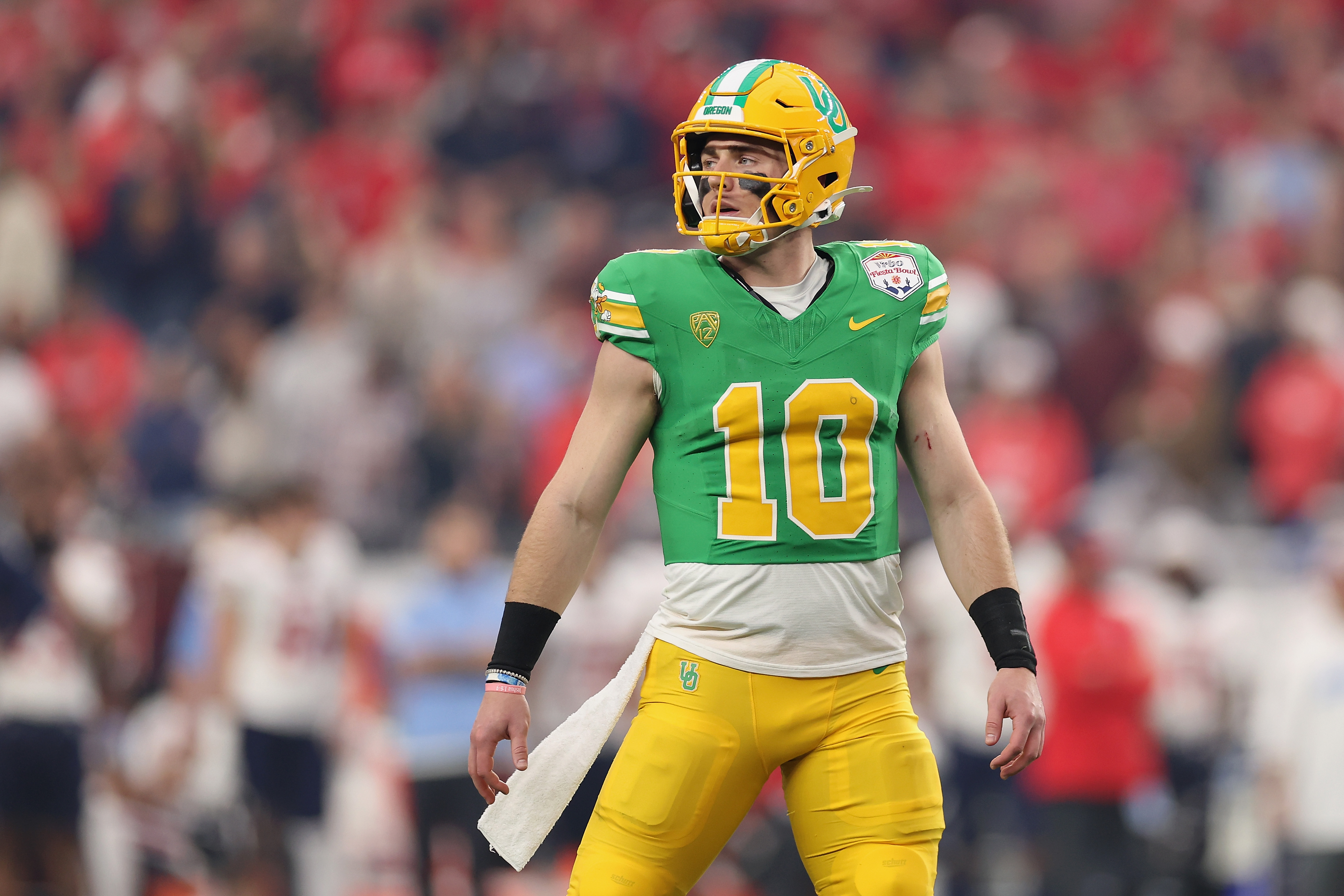 Quarterback Bo Nix #10 of the Oregon Ducks walks off the field during the first half of the Fiesta Bowl against the Liberty Flames at State Farm Stadium on January 01, 2024 in Glendale, Arizona. The Ducks defeated the Flames 45-6.