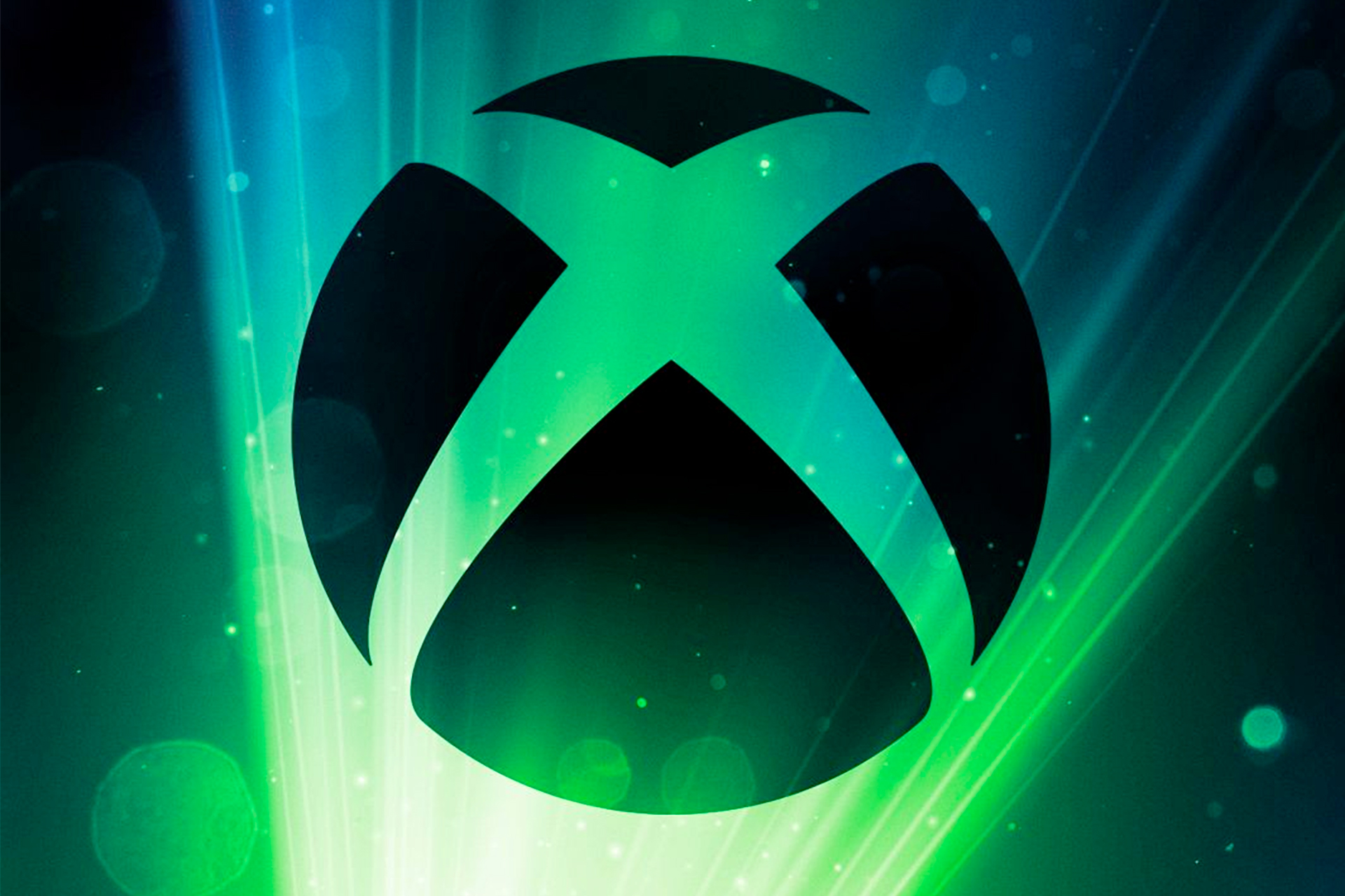The Xbox logo silhouetting a spotlight background